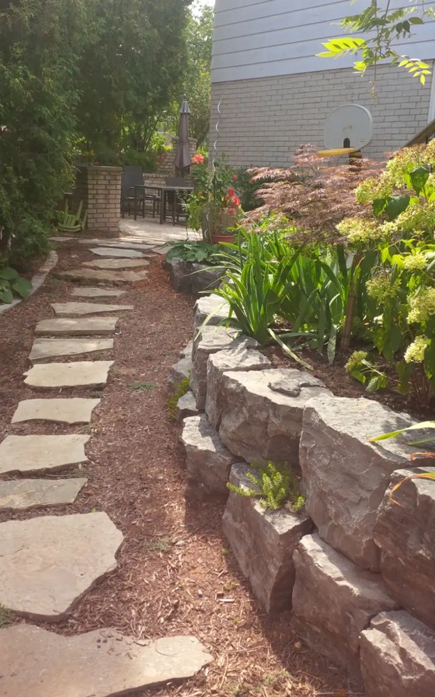Natural stone retaining wall with stepping stones