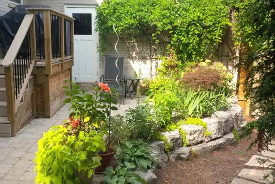 Retaining wall, brick patio, composite landing, with plantings